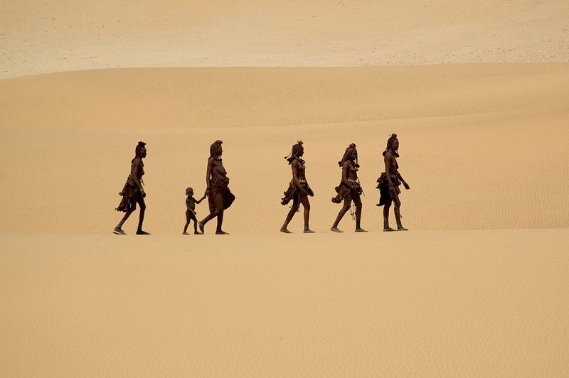 Himba tribe walking the Kaokoland dunes, the Skeleton Coast Namibia